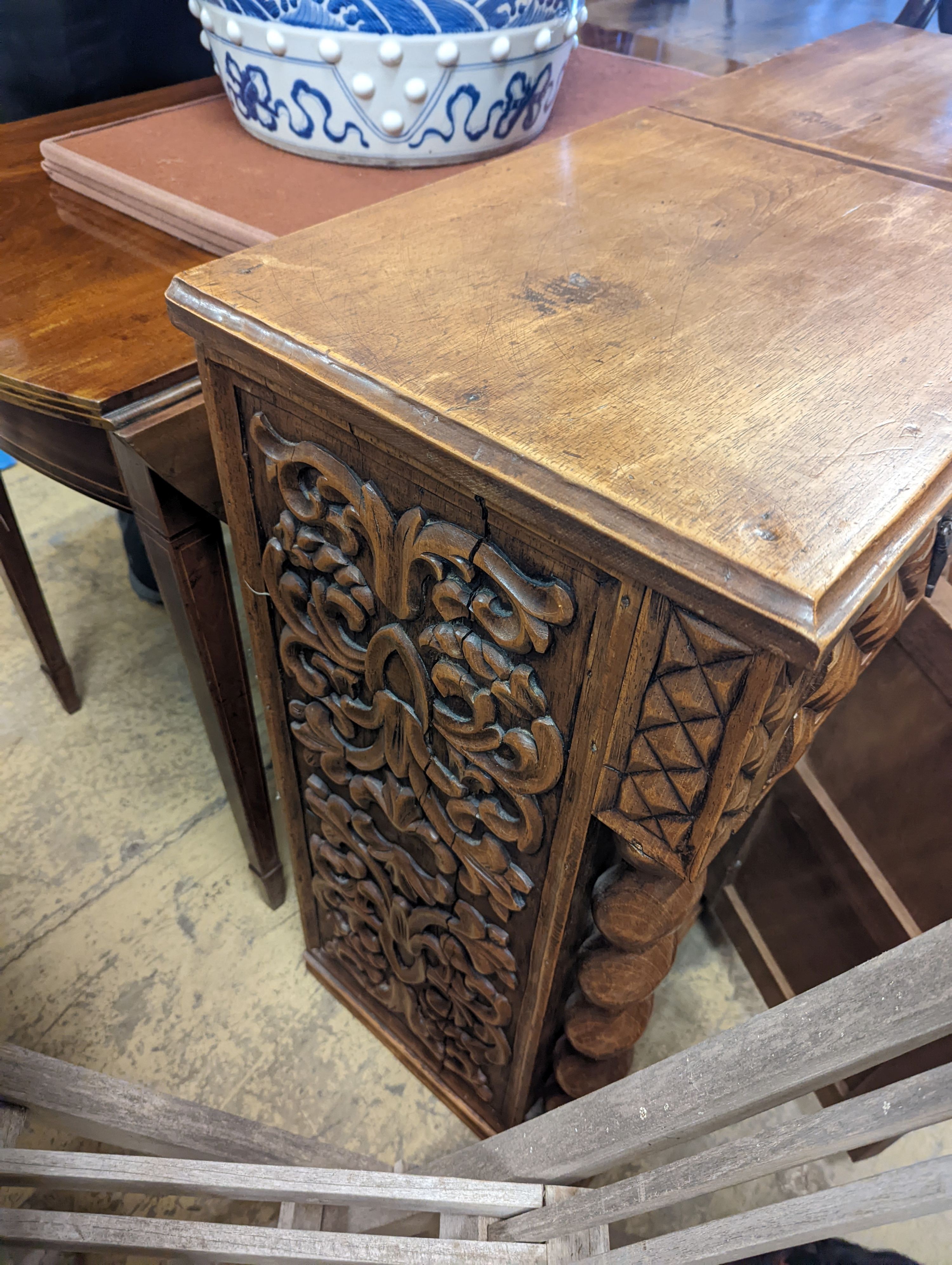 A pair of Spanish style carved walnut bedside cabinets, width 48cm, depth 38cm, height 79cm